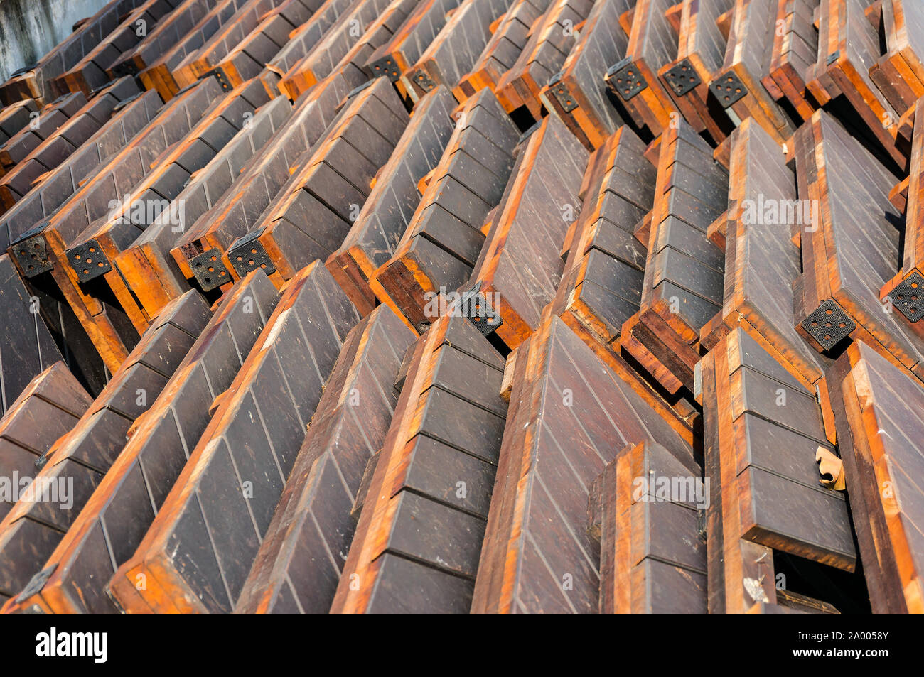 Construction material- stack of wood planks, boards. Stack of old wooden pallets Stock Photo