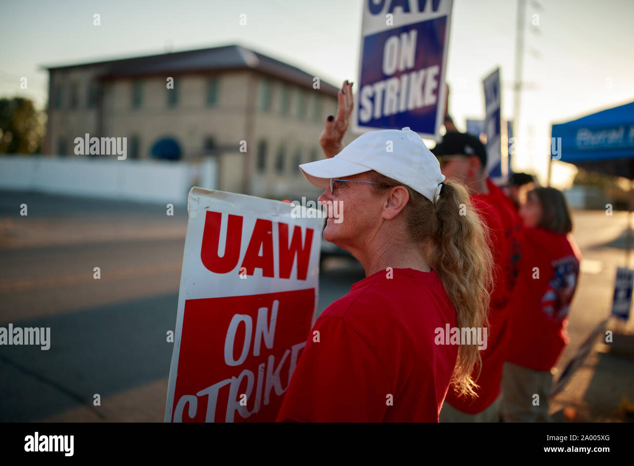 Workers from United Auto Workers Local 440 picket outside the General Motors Bedford Powertrain factory, where parts are molded from liquid metal, as the sun sets on day three of a nationwide worker strike against GM, Wednesday, September 18, 2019 in Bedford, Ind. The workers walked off the job at midnight on September 16th after their contract ran out, and are asking for better pay, affordable healthcare, that temp workers be made permanent, that jobs not be sent overseas, and that some factories, like the one in Lordtown, Ohio, be reopened. More than 700 workers at the Bedford, Indiana, fact Stock Photo