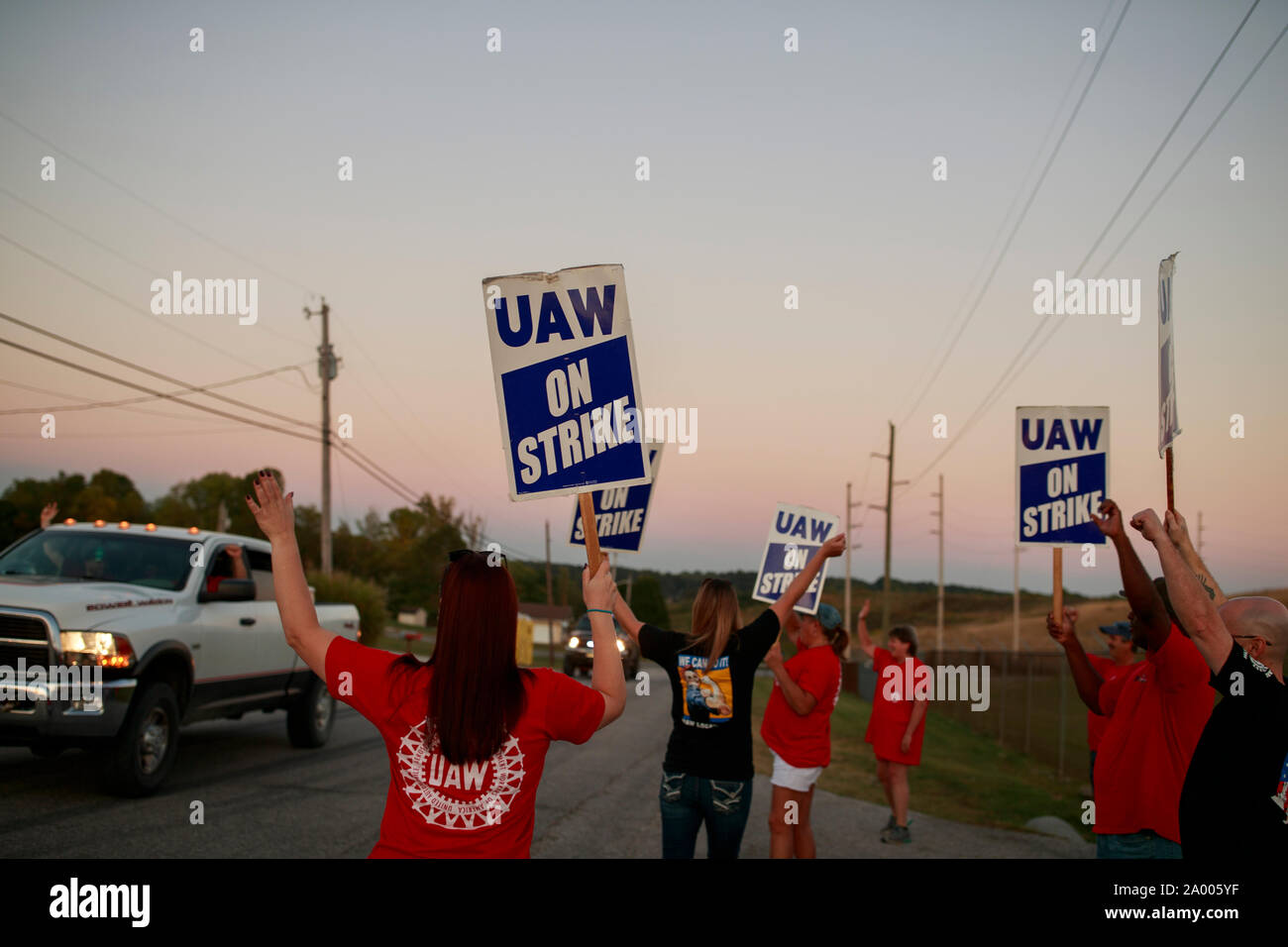 Workers from United Auto Workers Local 440 picket outside the General Motors Bedford Powertrain factory, where parts are molded from liquid metal, as the sun sets on day three of a nationwide worker strike against GM, Wednesday, September 18, 2019 in Bedford, Ind. The workers walked off the job at midnight on September 16th after their contract ran out, and are asking for better pay, affordable healthcare, that temp workers be made permanent, that jobs not be sent overseas, and that some factories, like the one in Lordtown, Ohio, be reopened. More than 700 workers at the Bedford, Indiana, fact Stock Photo