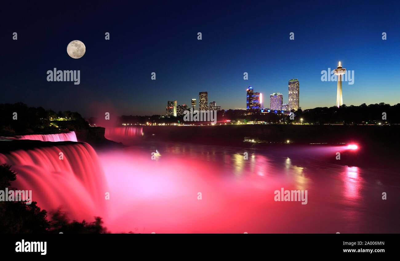 Niagara Falls at dusk including the moon and skyline of the Canadian city on the background Stock Photo