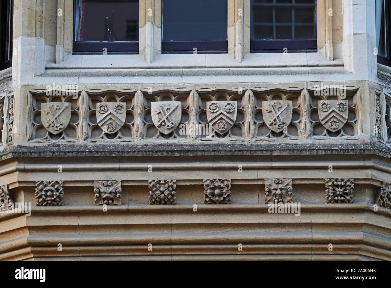 detail from 1890s on New College Oxford in Holywell Street, with the crests or coats of arms of New College and the Bishop of Winchester Stock Photo