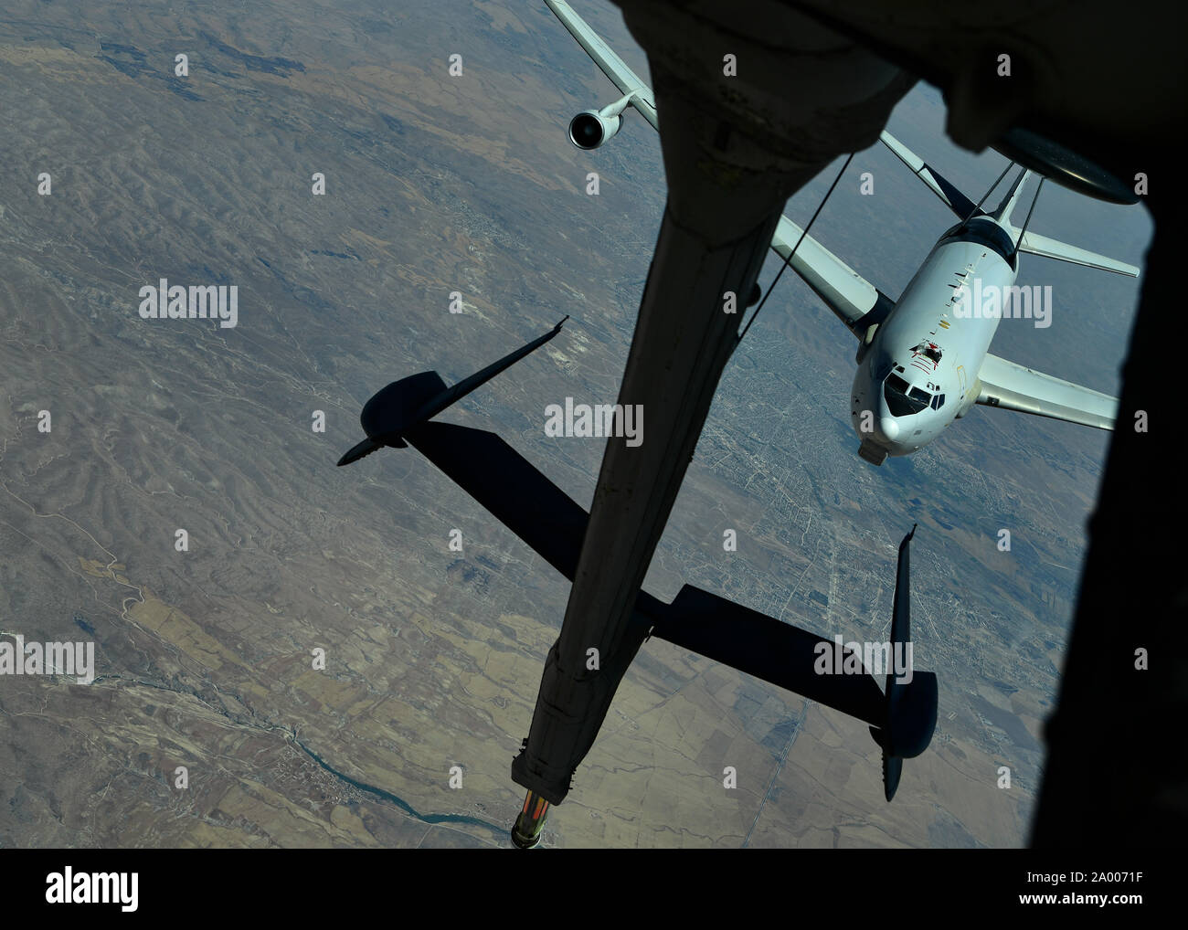 A U.S. Air Force E-3 Sentry (AWACS) prepares to connect with a KC-10 Extender, assigned to the 908th Expeditionary Air Refueling Squadron, out of Al Dhafra Air Base, United Arab Emirates, above an undisclosed location, Sept. 1, 2019. The 908th EARS, part of U.S. Air Forces Central Command, is responsible for delivering fuel to U.S. and coalition forces, enabling a constant presence in the area of responsibility. (U.S. Air Force photo by Staff Sgt. Chris Drzazgowski) Stock Photo