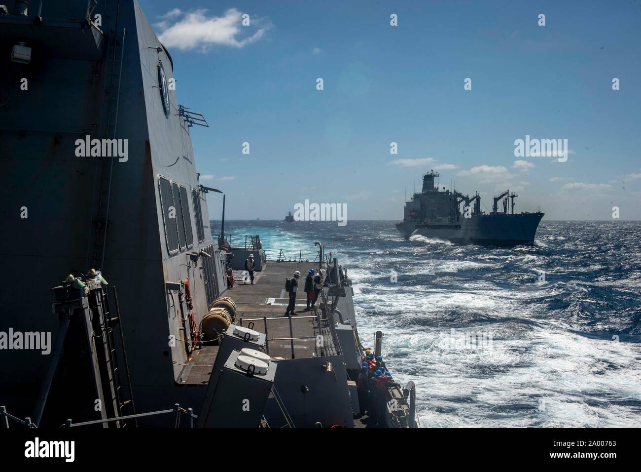 190918-N-MW694-0386 EAST CHINA SEA (Sept. 18, 2019) The Arleigh Burke-class guided-missile destroyer USS William P. Lawrence (DDG 110) breaks away from the fleet replenishment oiler USNS Pecos (T- AO 197) after an underway replenishment. William P. Lawrence is underway conducting routine operations in the Indo-Pacific region while assigned to Destroyer Squadron (DESRON) 15, the Navy's largest forward deployed DESRON and the U.S. Seventh Fleet's principal surface force. (U.S. Navy photo by Mass Communication Specialist 3rd Class Caledon Rabbipal/Released) Stock Photo