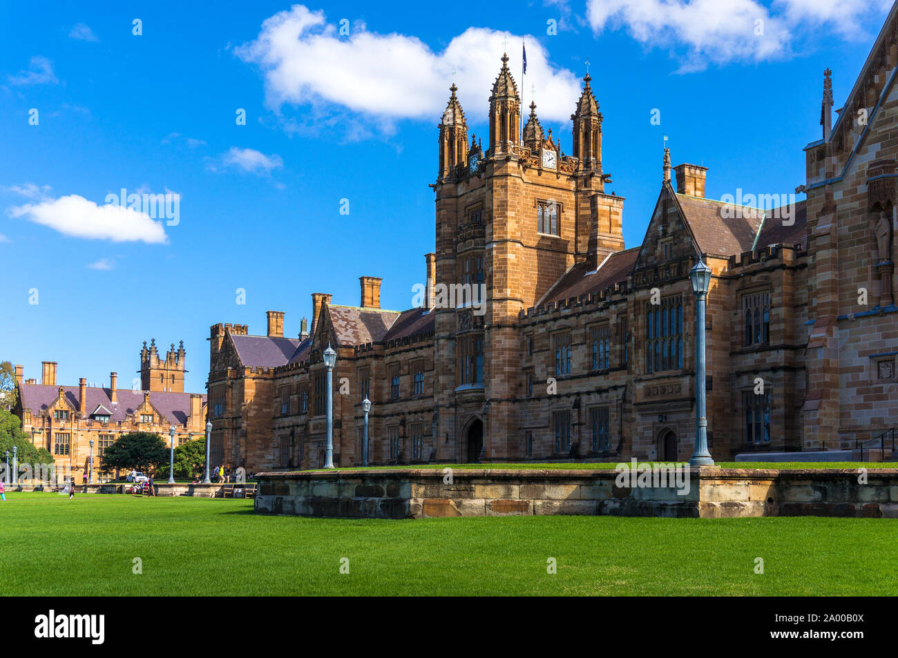 Sydney Uni building facade. University of Sydney against deep blue sky with white clouds, daytime photo Stock Photo