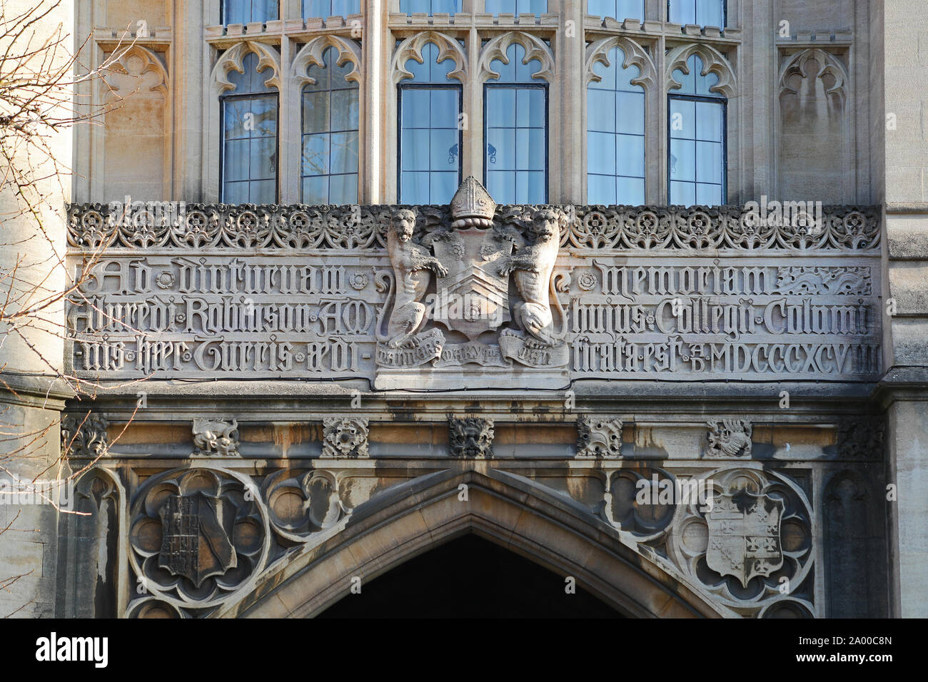 detail on the back entrance gate to New College Oxford on the Robinson tower built in 1896 has the college coat of arms and leads to Holywell Street Stock Photo