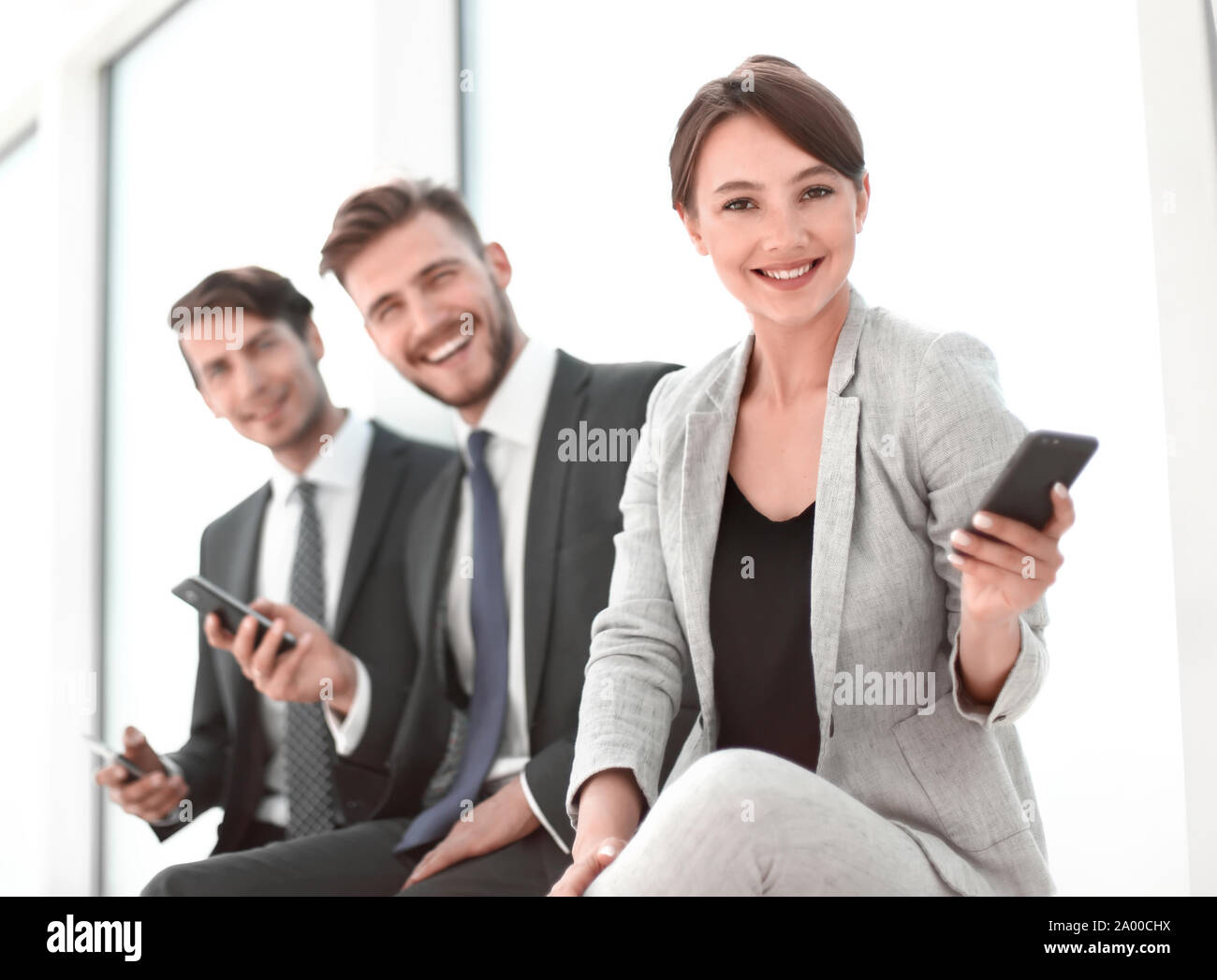 successful business team sitting in the office lobby Stock Photo - Alamy