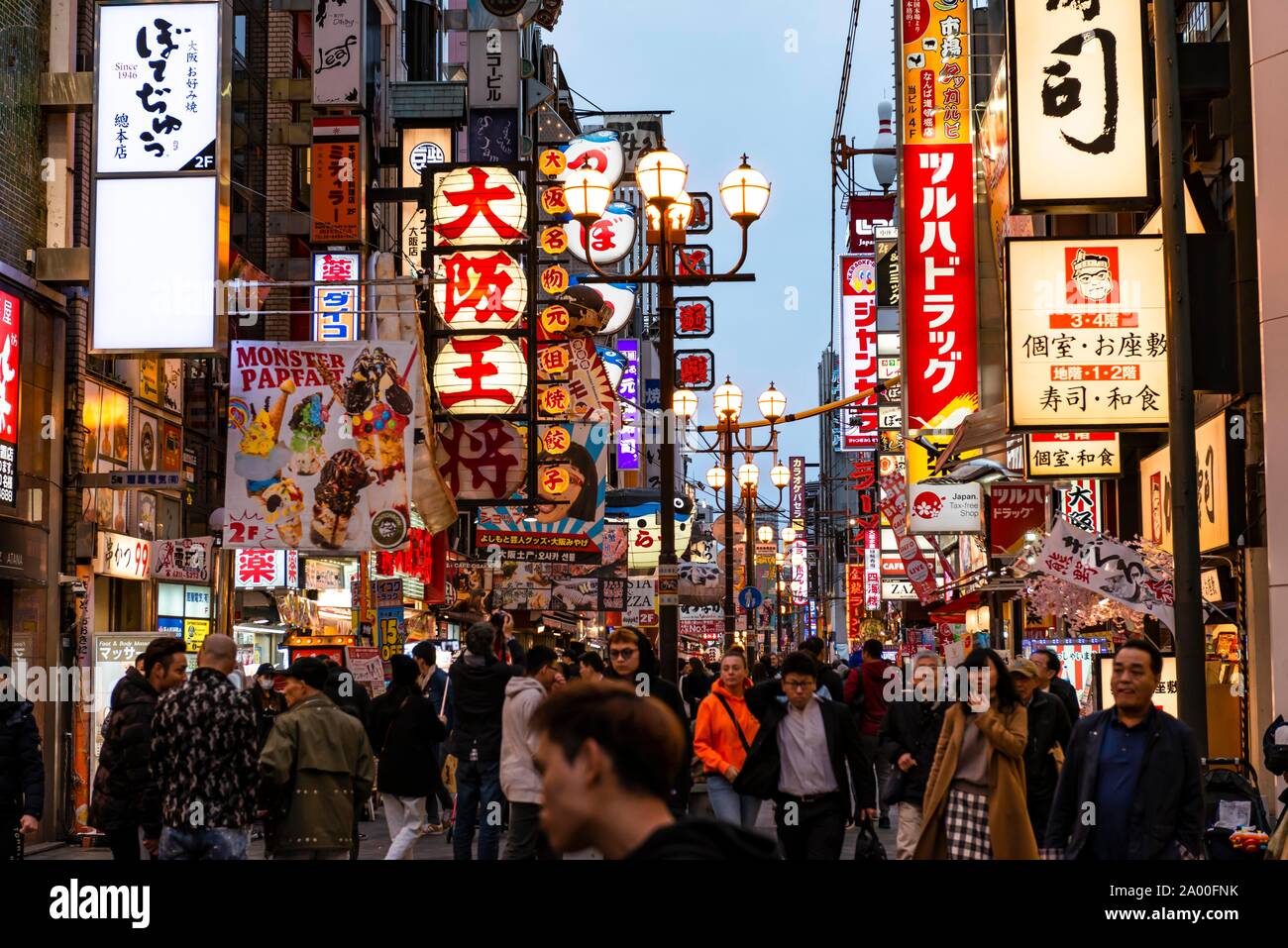 Crowd crowded in pedestrian zone with lots of illuminated advertising for restaurants and shopping centers, Dotonbori, Osaka, Japan Stock Photo