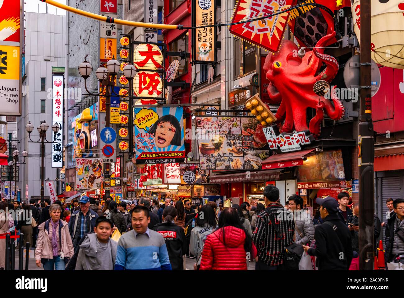 Crowd crowded in pedestrian zone with lots of illuminated advertising for restaurants and shopping centers, Dotonbori, Osaka, Japan Stock Photo