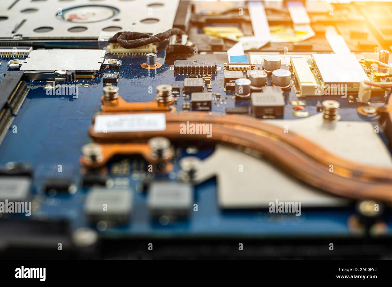 Technician repairing broken laptop notebook computer with screwdriver Stock Photo