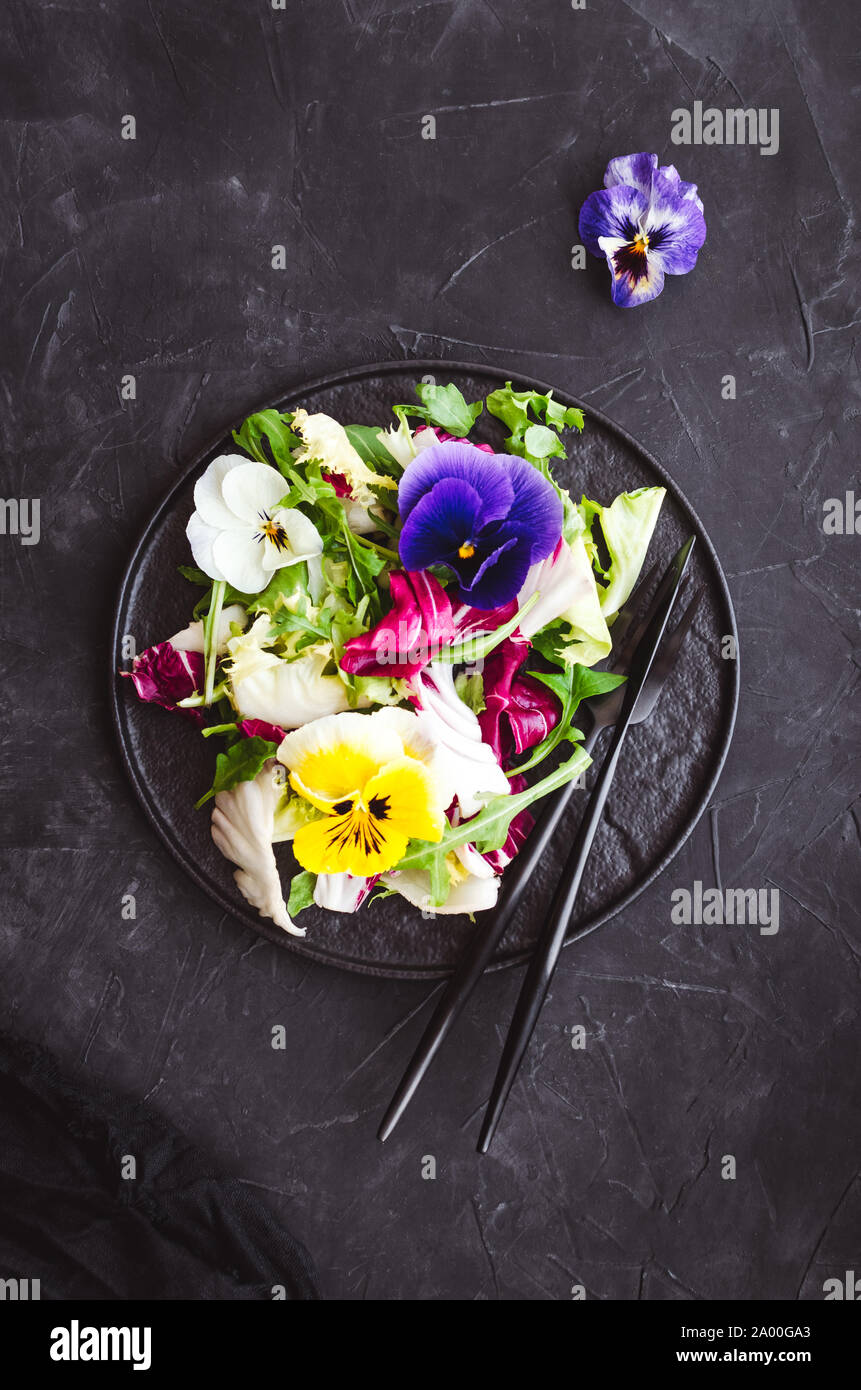 Healthy salad with green and purple lettuce and edible flowers. Stock Photo