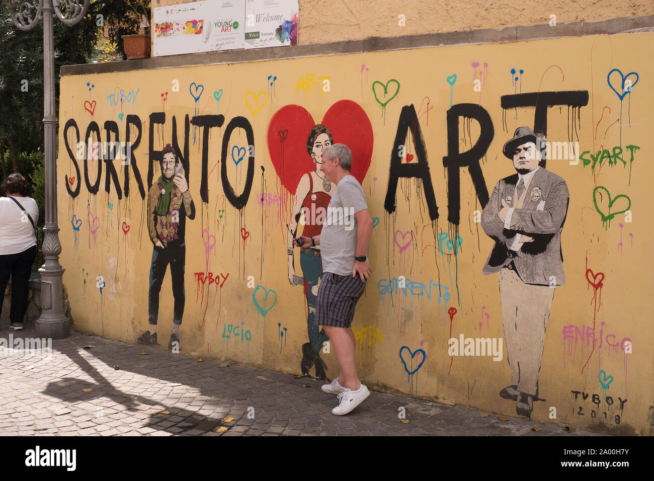 Tourist in front of atreet art in Sorrento in Italy Stock Photo