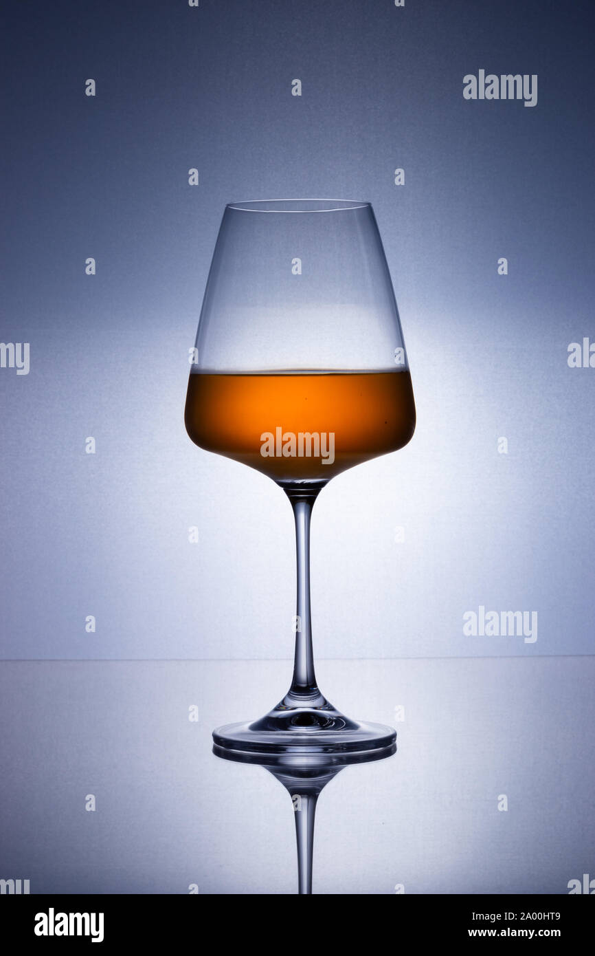 Wine glass on a reflective surface Stock Photo