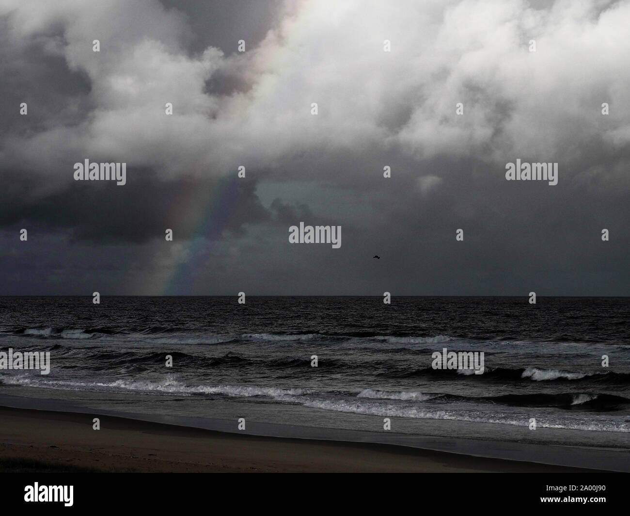 After the rain, dark storm clouds over the ocean, a dramatic grey ...