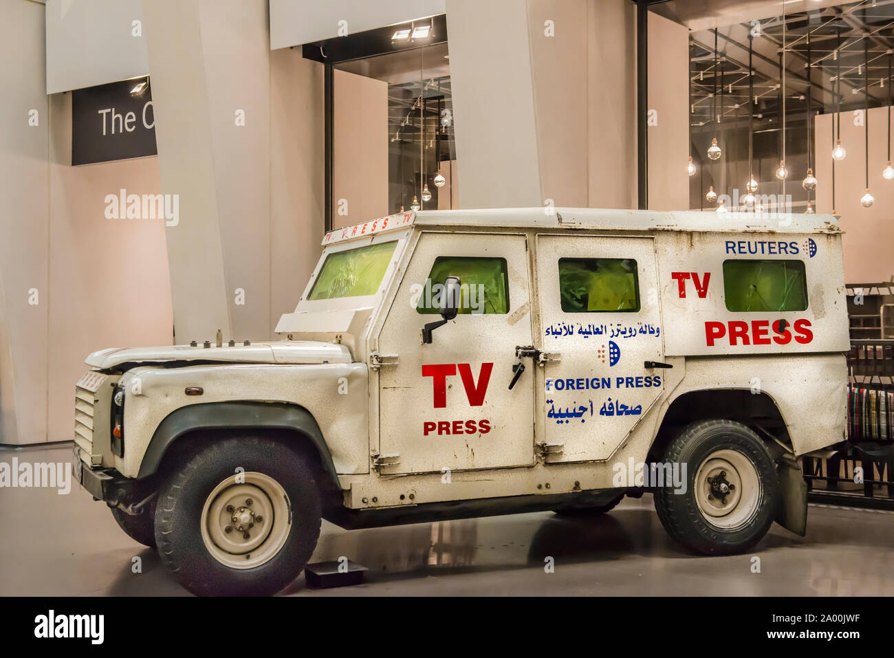 Imperial War Museum exhibit, TV, Press armored vehicle used by reporters covering war zones. Copy Space. War damage visible. Arabic and English ID. Stock Photo