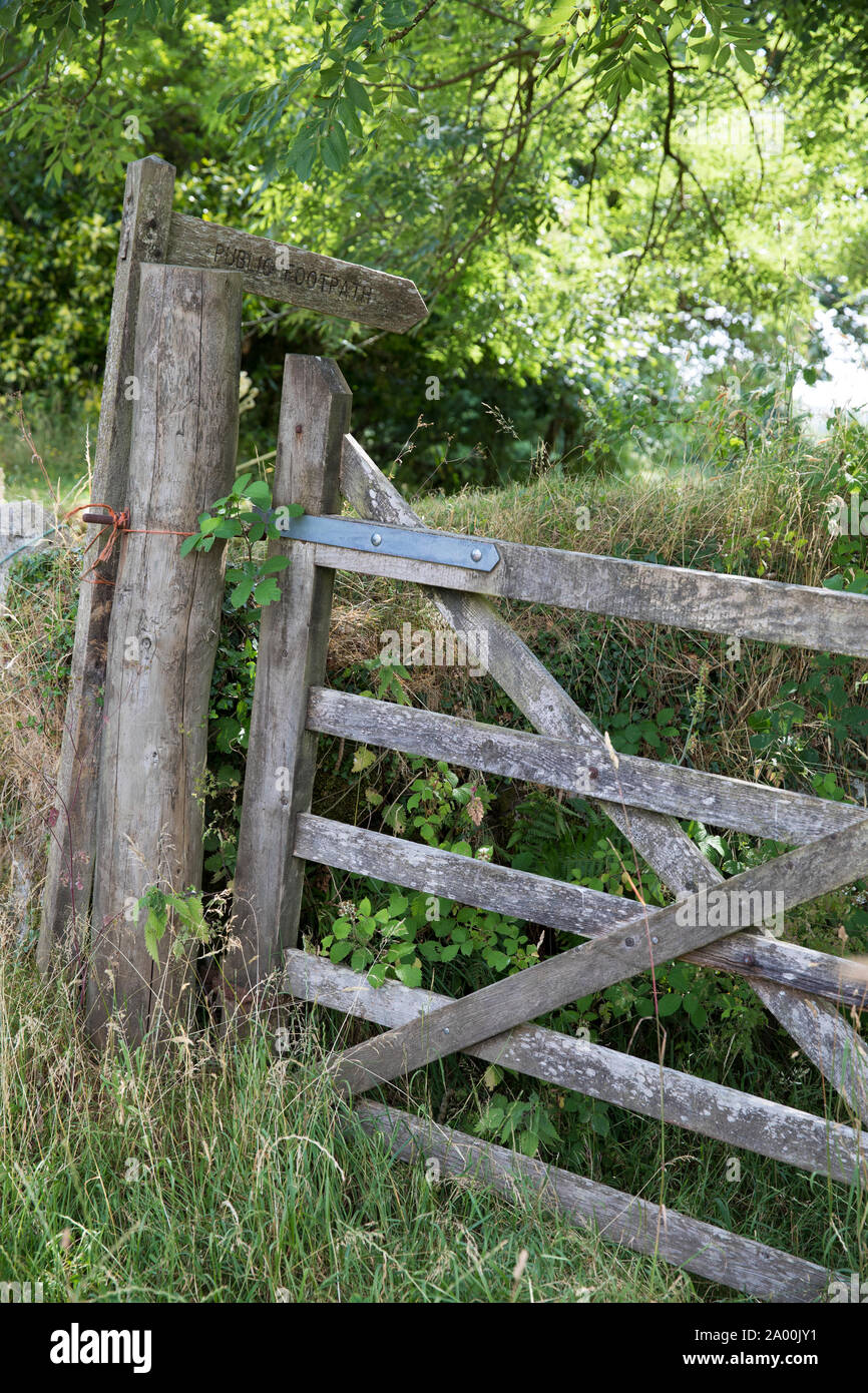 Signposted Walking trail signposted by Public Footpath sign in a rural scene on ...