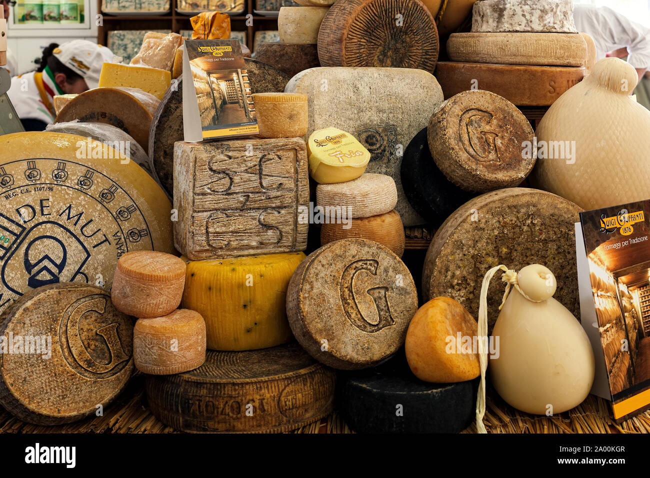 Different types of artisan smoked hard cheese on the stall during traditional International Cheese Market. Stock Photo