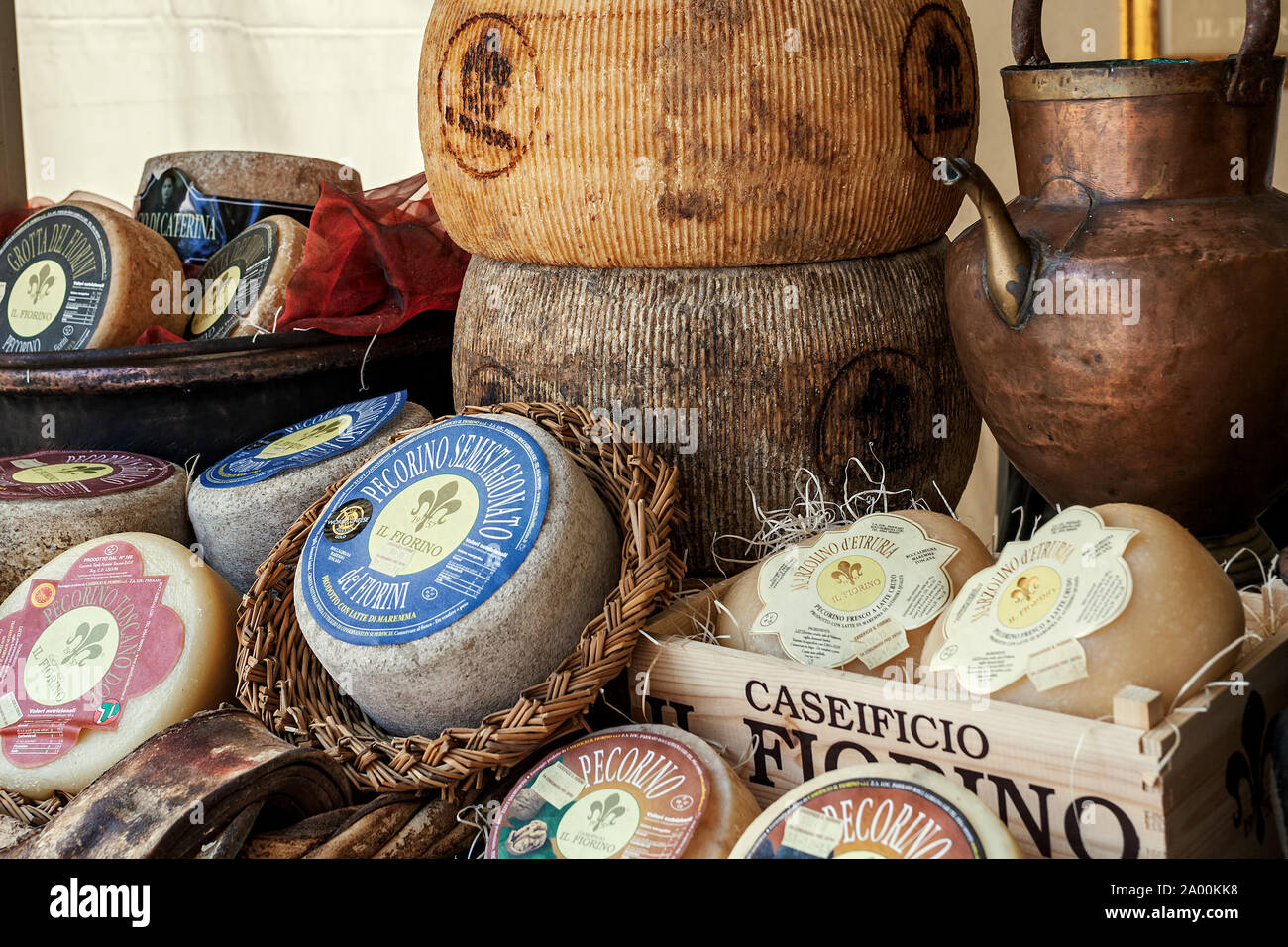 Different types of artisan smoked hard and pecorino cheese on the stall during traditional International Cheese Market. Stock Photo