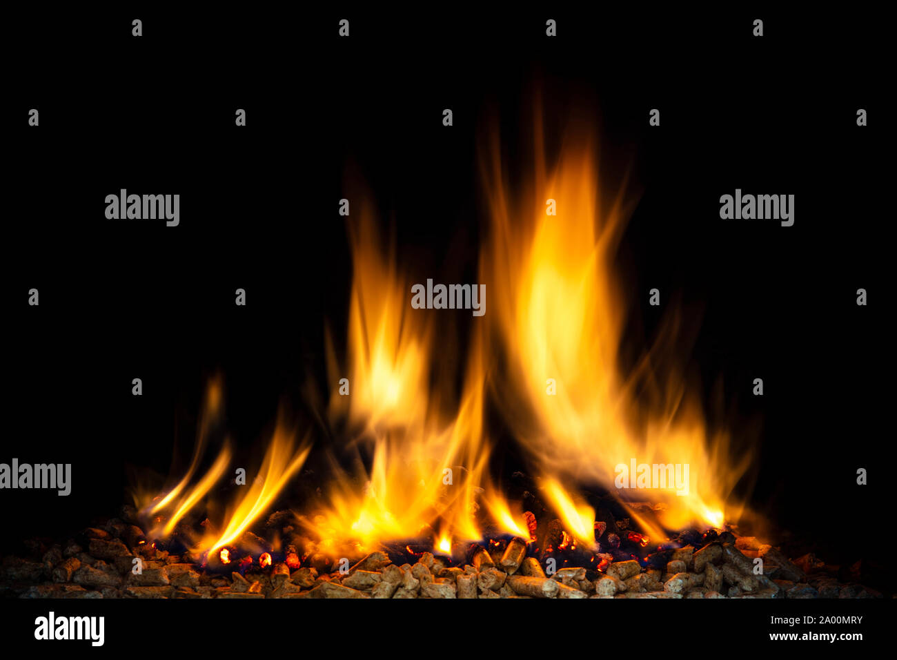 burning wood pellets, visible flame and dark background. biomass and