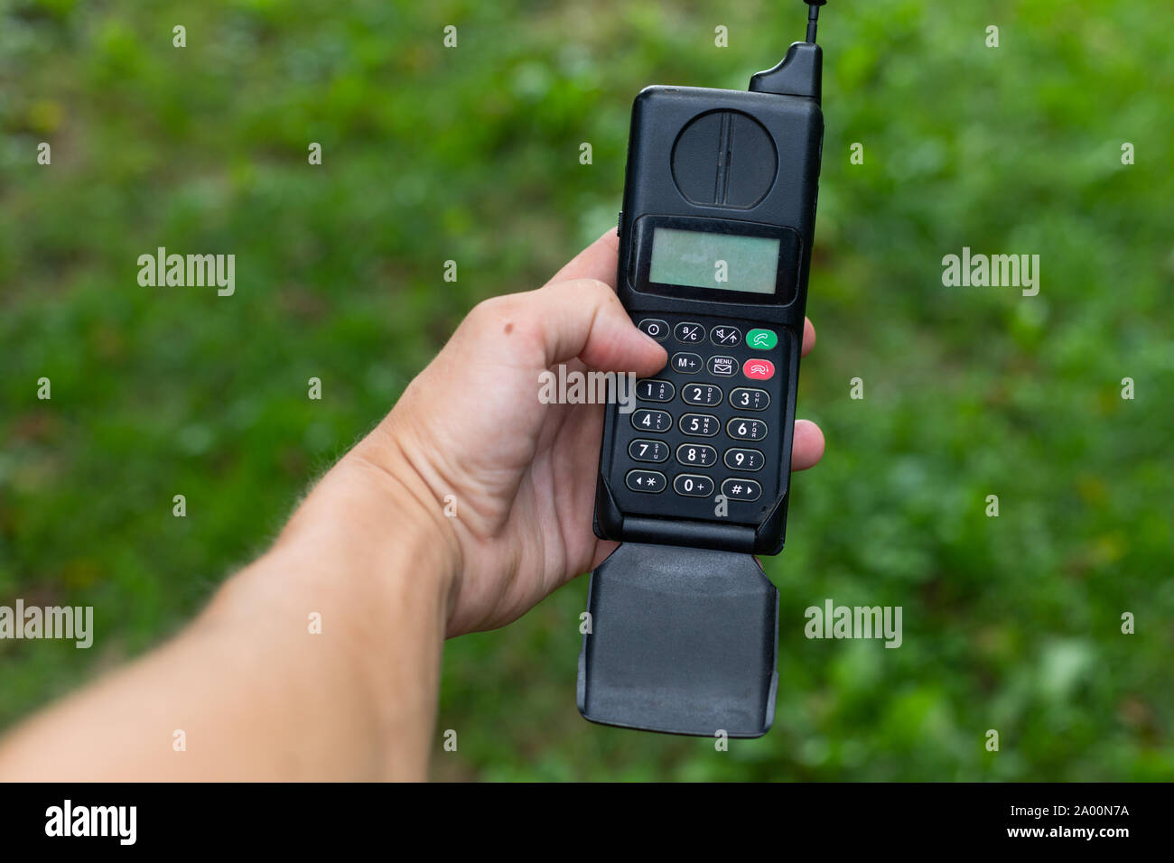 Picture of a man holding brick cell phone Stock Photo