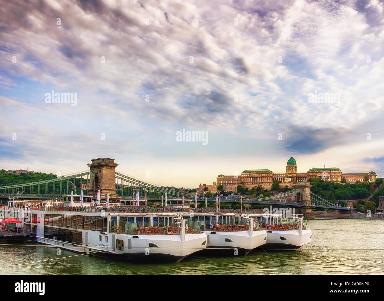 Budapest, Hungary, Aug 2019, Viking River Cruises boat on the Danube River opposite the Szechenyi Chain Bridge and the Buda castle at sunset Stock Photo