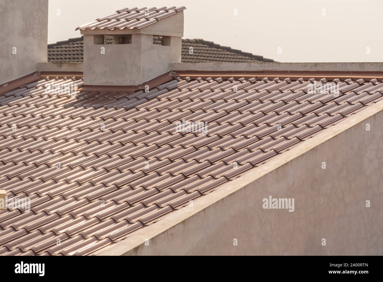 View of different roofs constructed of clay tiles in residential