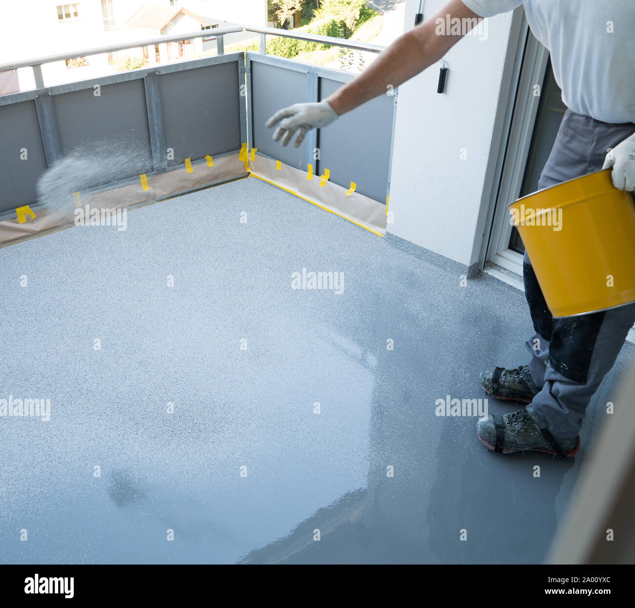 A Construction Worker Renovates Balcony Floor And Spreads Chip