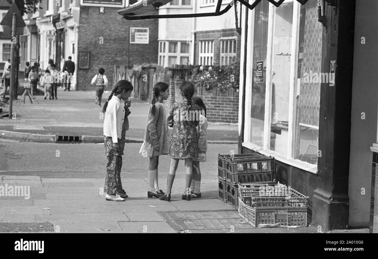 Southall, London 1972. Asian children street scene. After Idi Amin ordered 30,000 Asians out of Uganda with 90 days notice, those with British Passports headed to England. They were forced to leave their money, property and possessions behind. These images document life for some of the people as they settled in Southall, west of London. An insight into life 47 years ago for immigrants in the UK. Photo by Tony Henshaw Stock Photo
