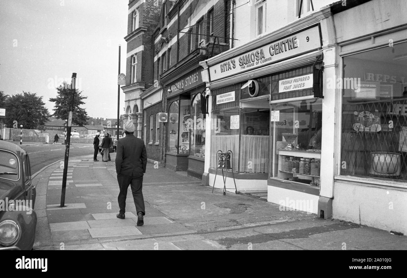 Southall, London 1972. Sikh men on the high street. After Idi Amin ordered 30,000 Asians out of Uganda with 90 days notice, those with British Passports headed to England. They were forced to leave their money, property and possessions behind. These images document life for some of the people as they settled in Southall, west of London. An insight into life 47 years ago for immigrants in the UK. Photo by Tony Henshaw Stock Photo