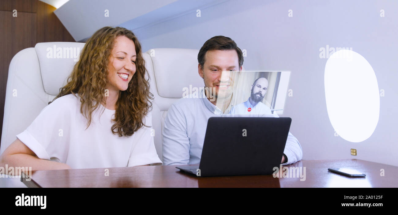 Making video call on private plane Stock Photo