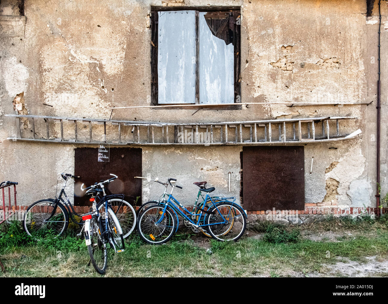 Bicycle parking next to old weathered wall in the Big Garden. Grosser
