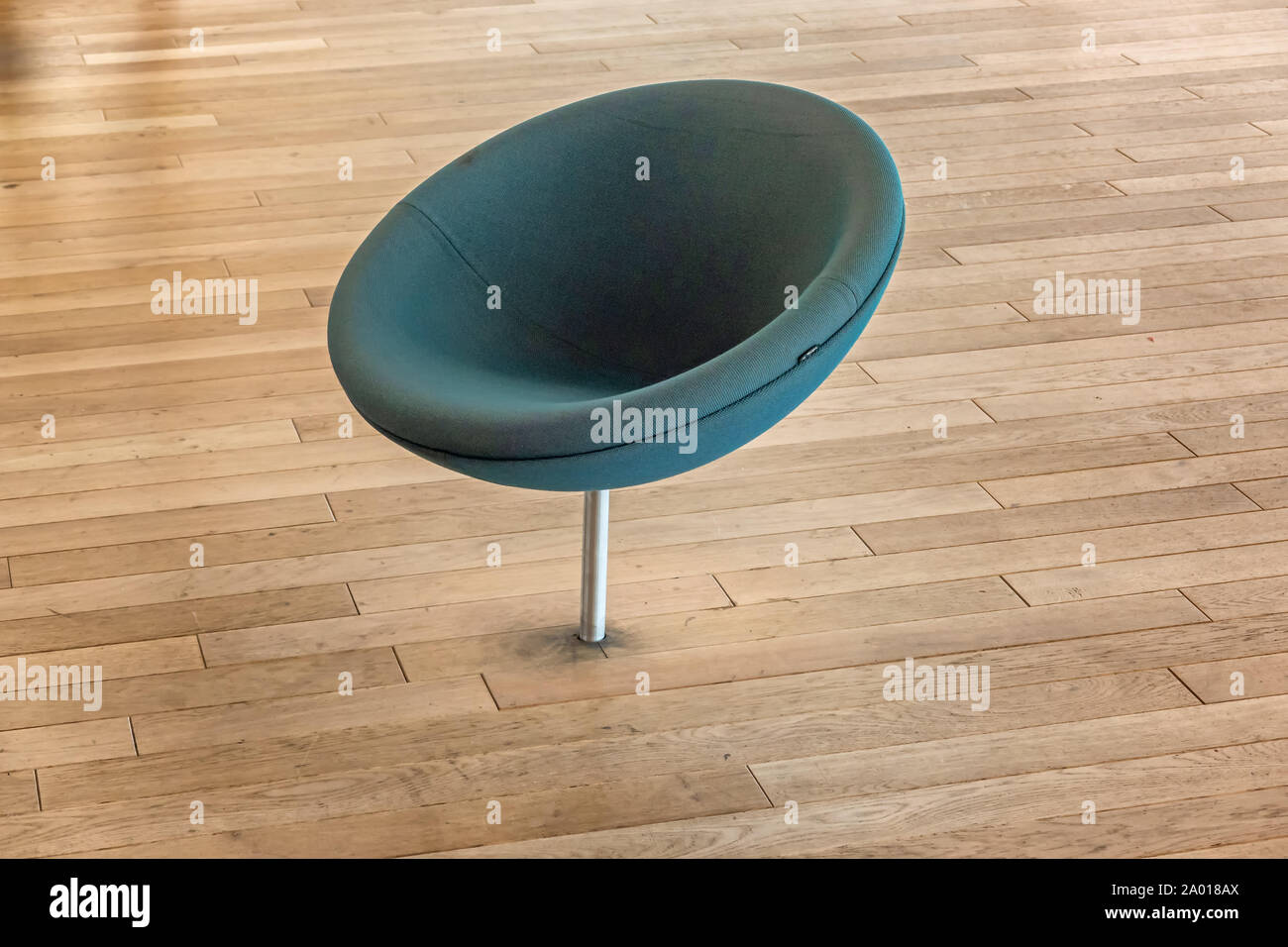 Round green chair mounted in the floor, public library Helsinki, Finland Stock Photo