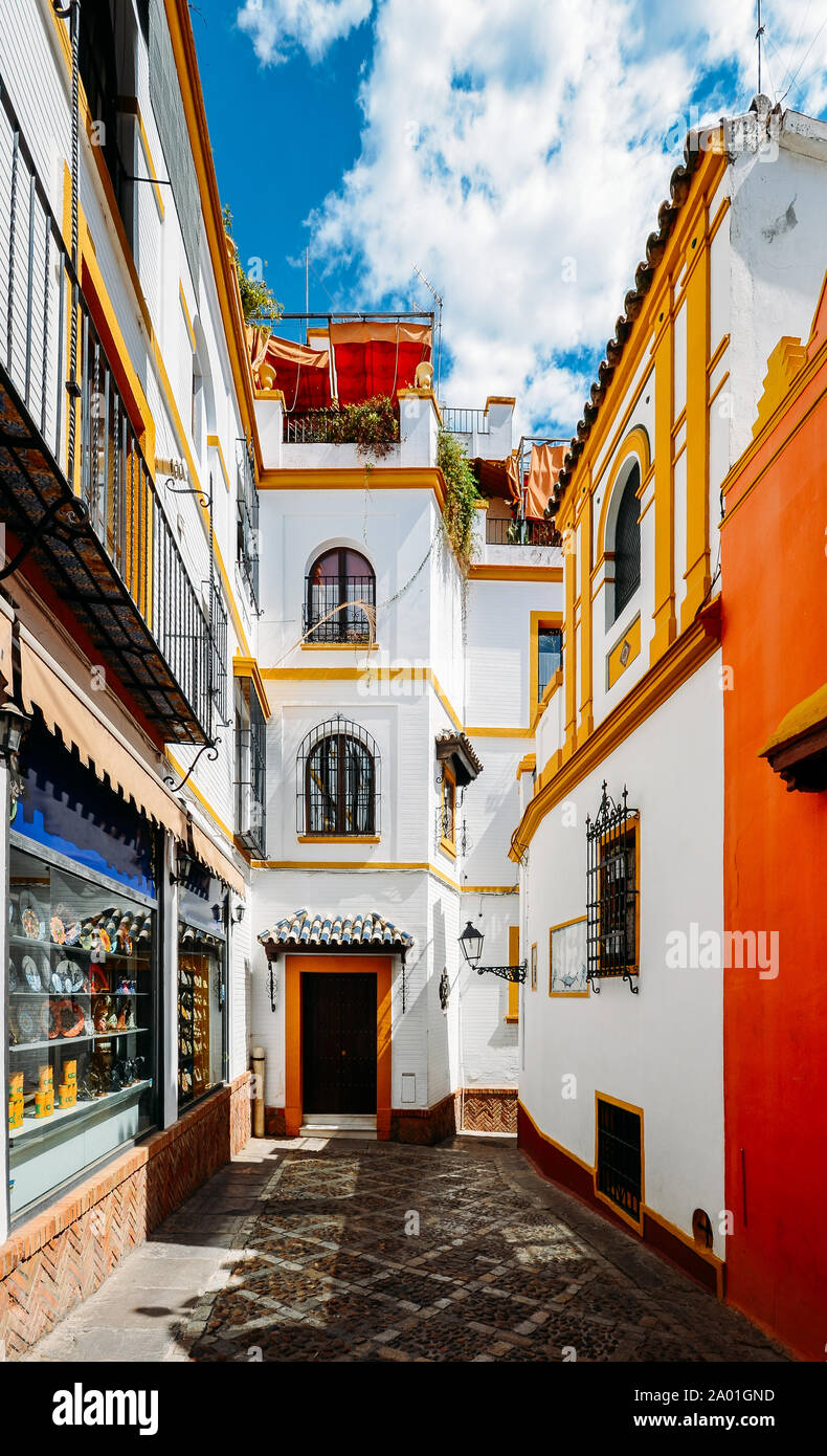 Old picturesque passageway in the medieval Jewish Quarter of Santa Cruz in Seville, Andalusia, Spain. Stock Photo