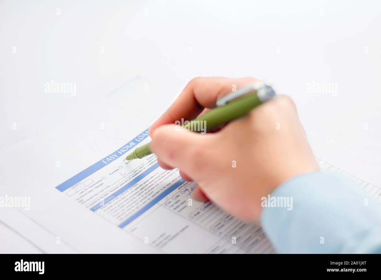 Picture of man working paperwork with a pen. Isolated on a white background. Stock Photo