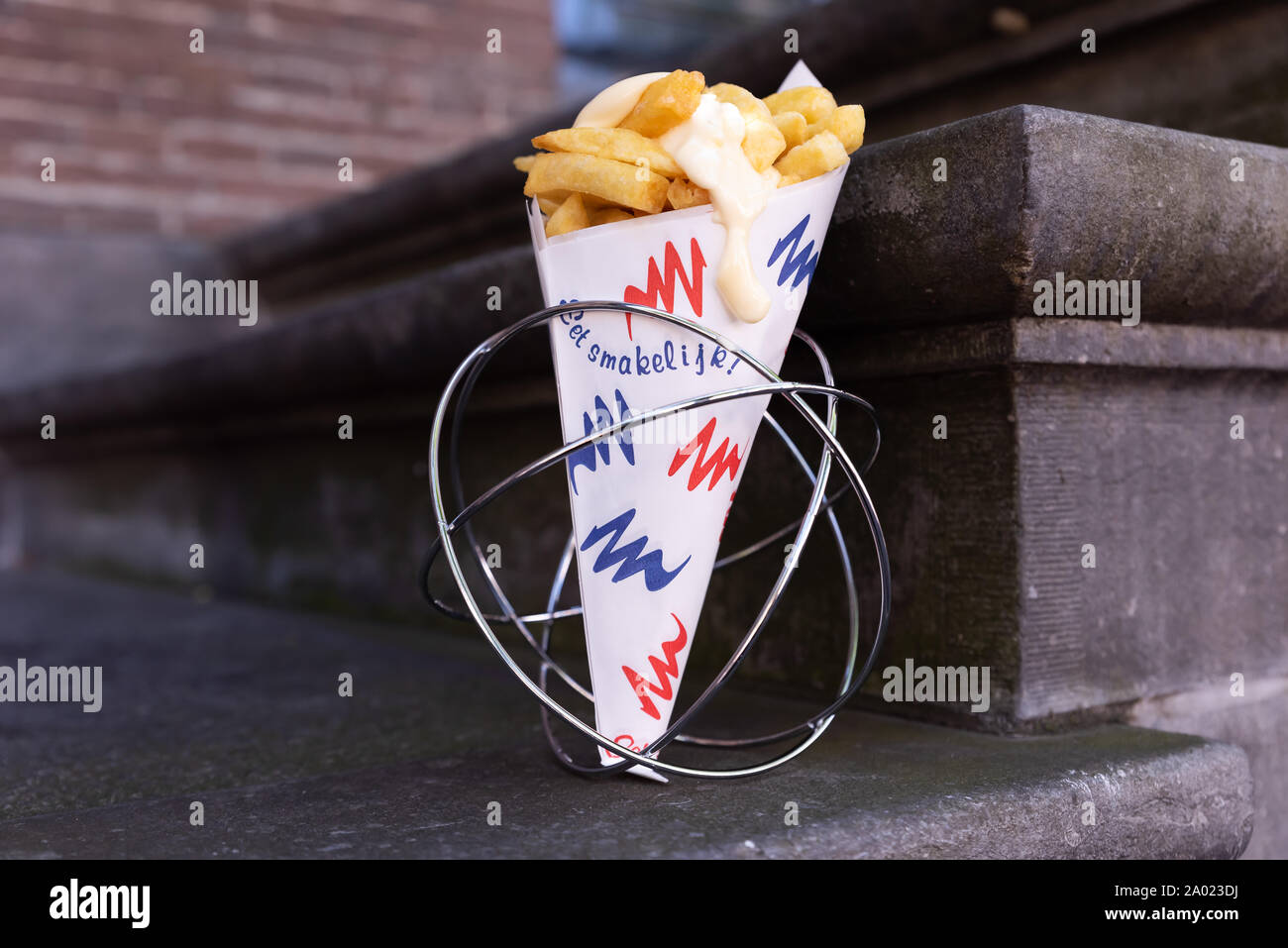 paper cone with french fries and mayonaise in a metal stand in dutch coliors red white blue Stock Photo