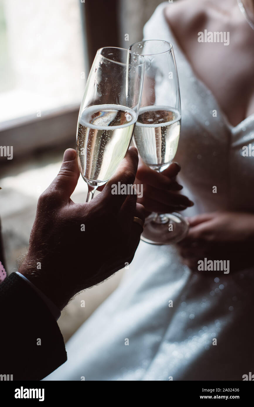 Close Up Of Married Couple Toasting Champagne Glasses At Wedding