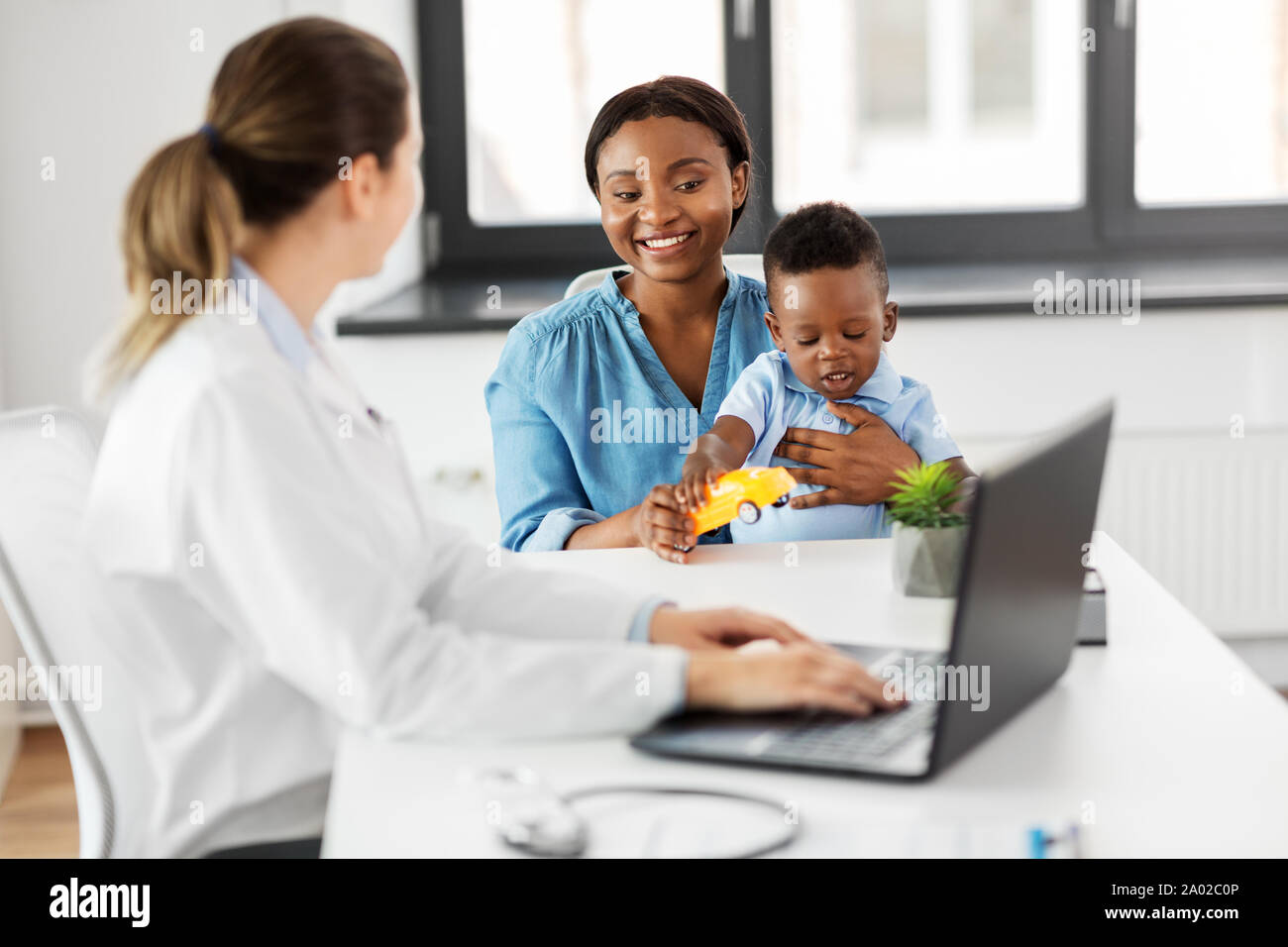 happy mother with baby son and doctor at clinic Stock Photo - Alamy