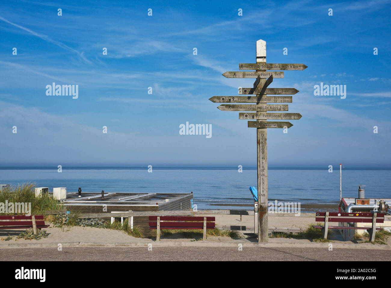 De Koog, Texel / North Netherlands - August 2019: Wooden signpost showing in multiple different directions at beach on island Texel Stock Photo
