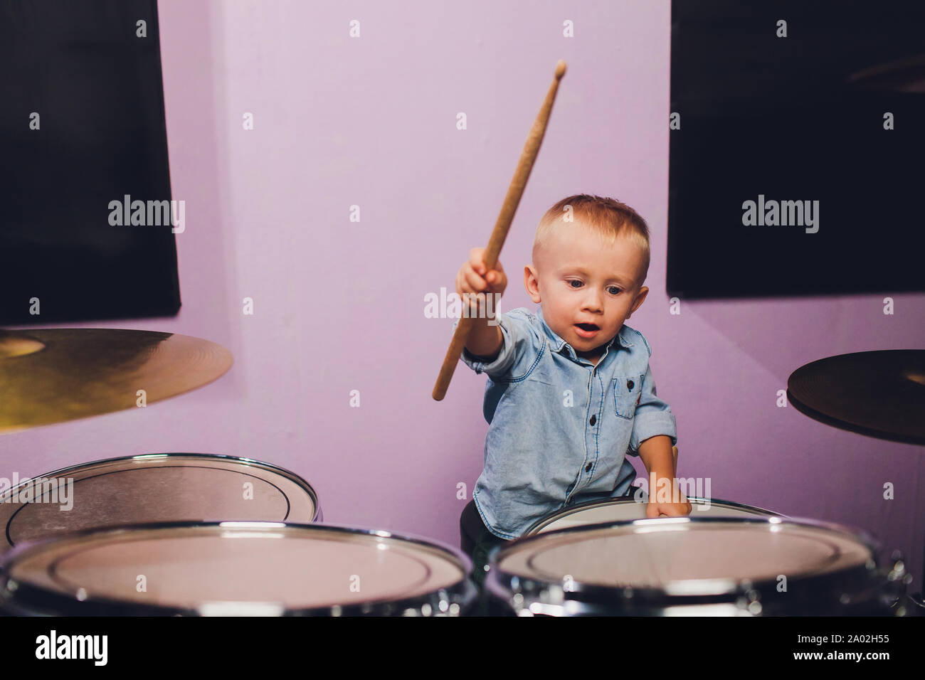little boy plays drums in recording studio Stock Photo Alamy