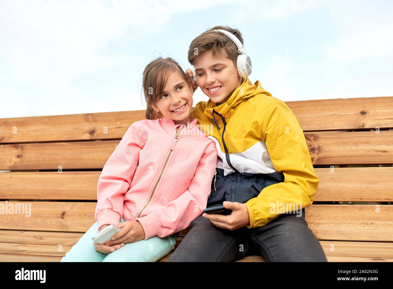 bou and girl with headphones listening to music Stock Photo - Alamy