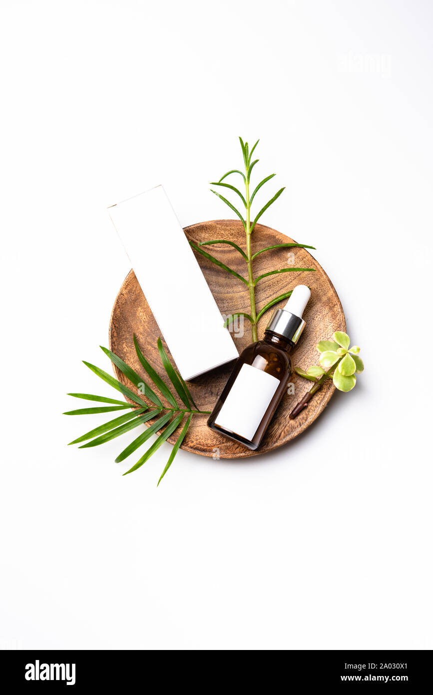 Download Brown Glass Cosmetic Bottle Mock Up With Blank White Label And Green Leaves Serum Packaging Stock Photo Alamy