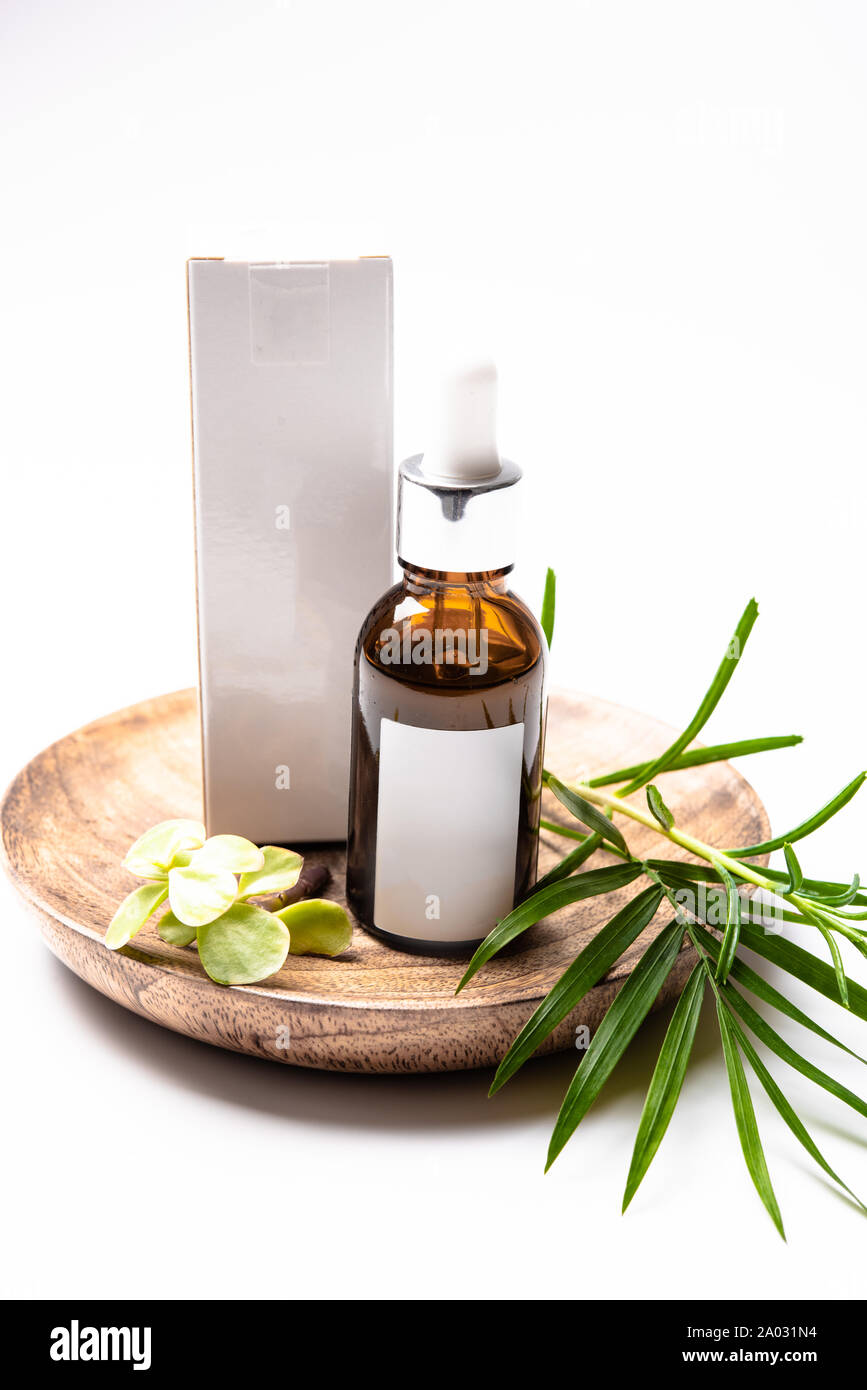 Download Brown Glass Cosmetic Bottle Mock Up With Blank White Label And Green Leaves Serum Packaging Stock Photo Alamy