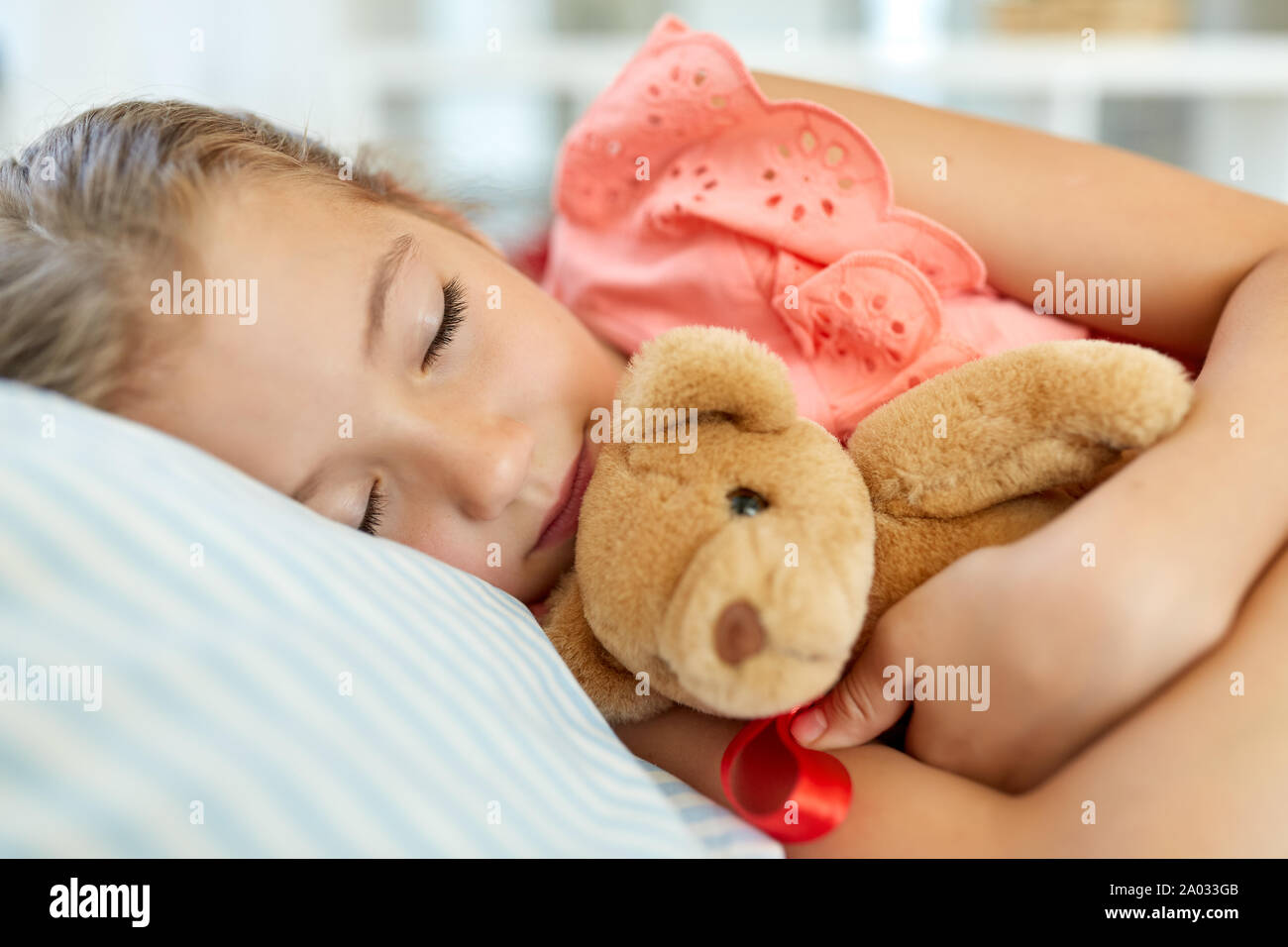 little girl sleeping with teddy bear toy at home Stock Photo Alamy