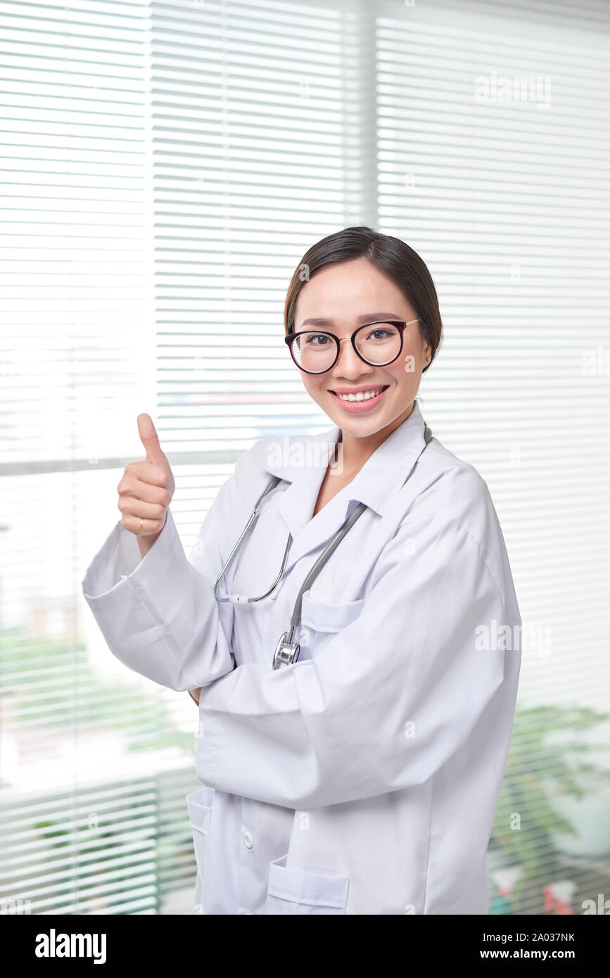 Female doctor show thumb up on office background Stock Photo - Alamy