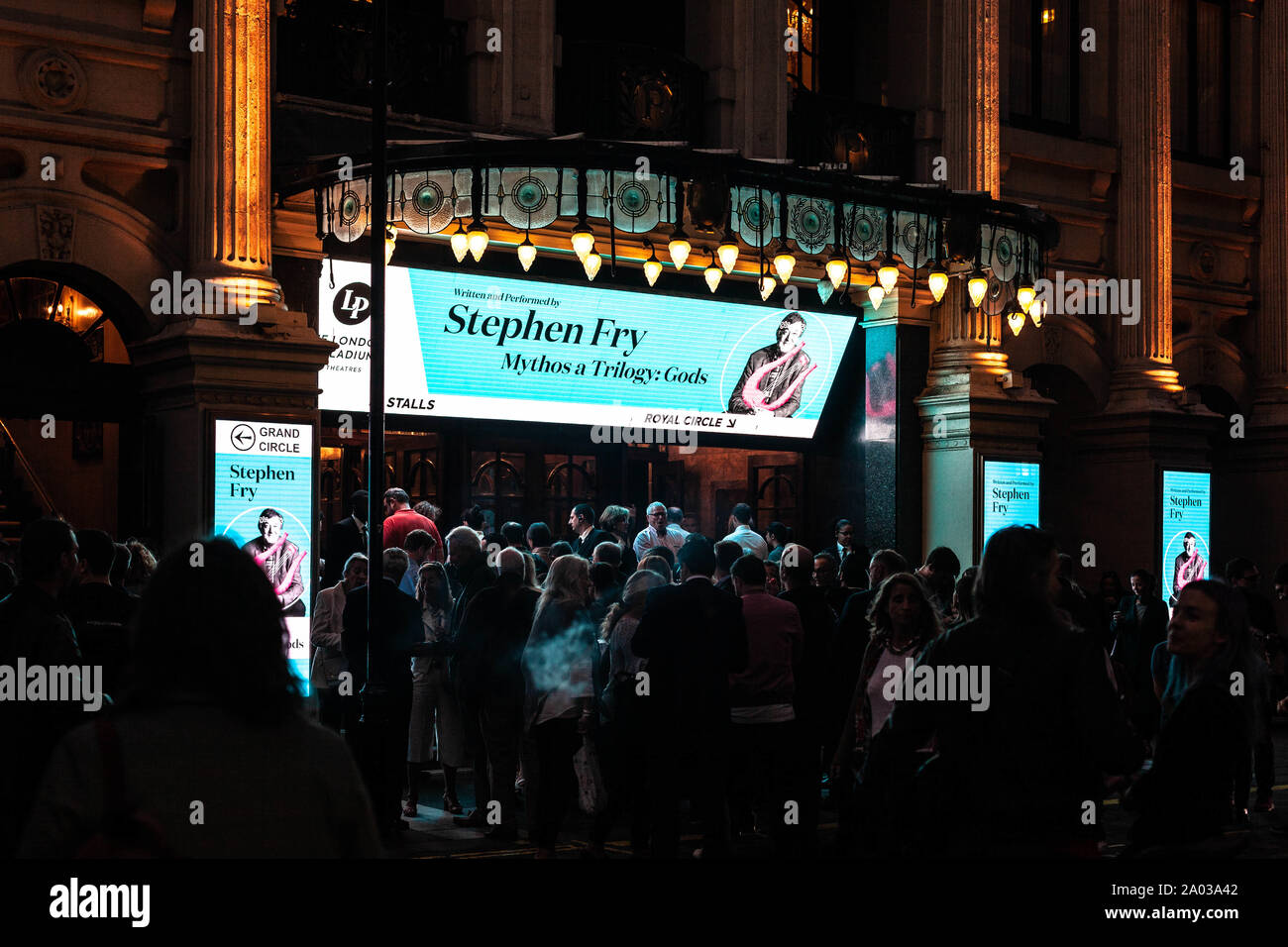 A big crowd awaits at the entrance of the London Palladium theatre to see Mythos a Trilogy by Stephen Fry, Argyll Street, Soho, London, England, UK. Stock Photo