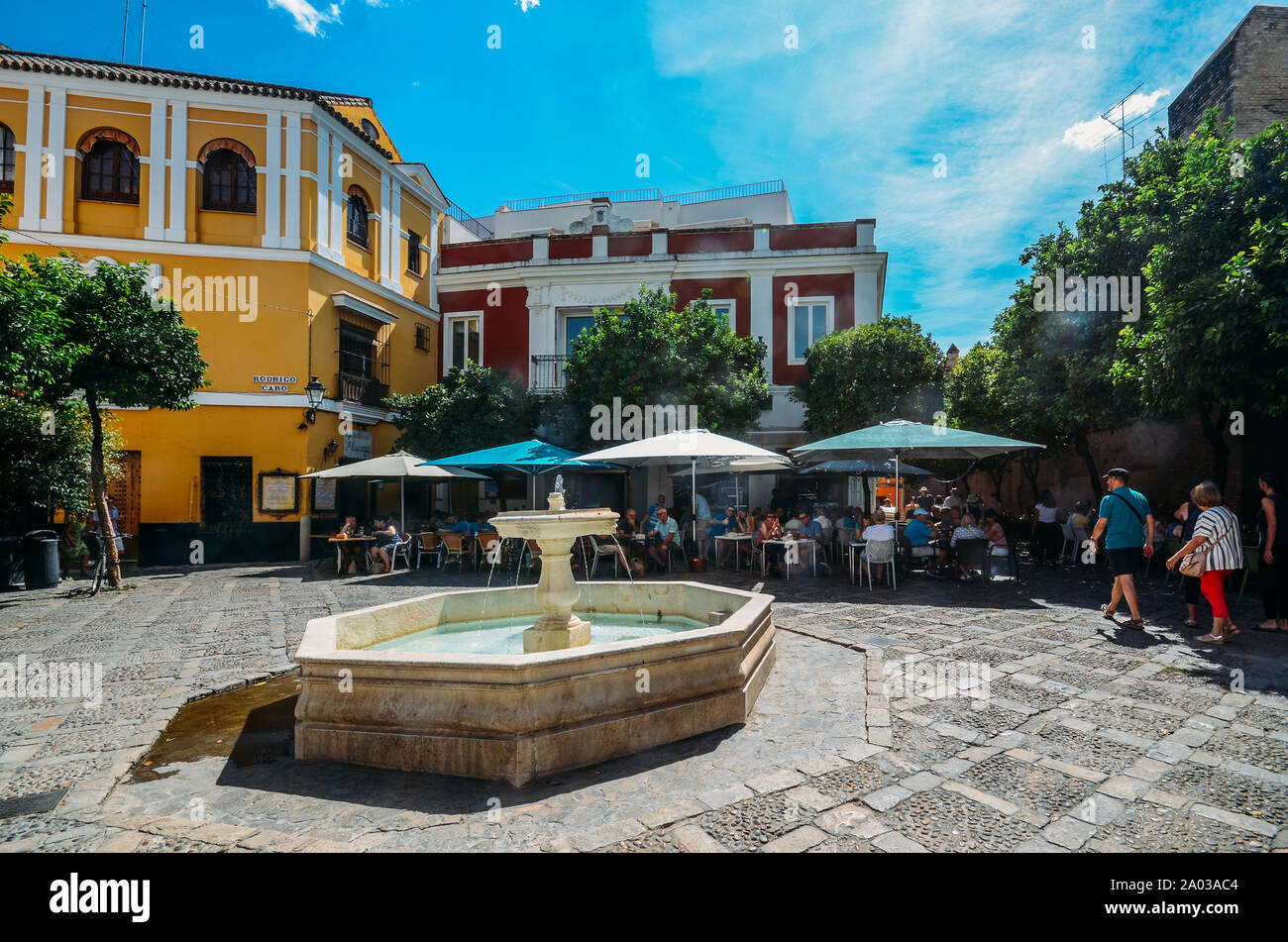 Seville, Spain - Sept 10, 2019: Tourists at Fuente de la plaza de la Alianza in the Jewish Quarter of Santa Cruz, Seville, Spain Stock Photo