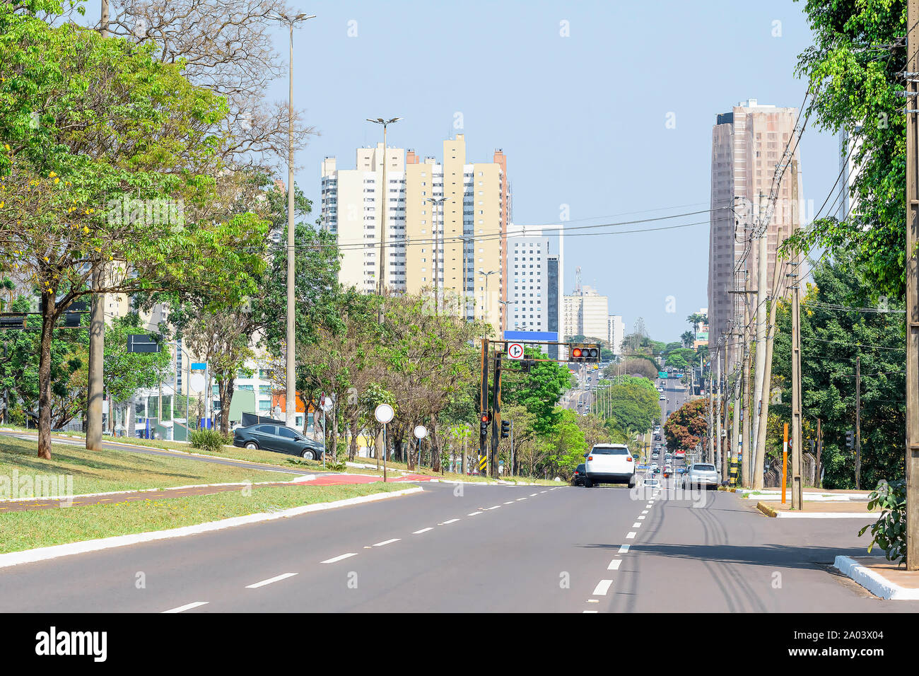 Tree-lined large avenue. City with many trees. Traffic at the Afonso Pena avenue - Campo Grande MS, Brazil. Main avenue of the city. Stock Photo