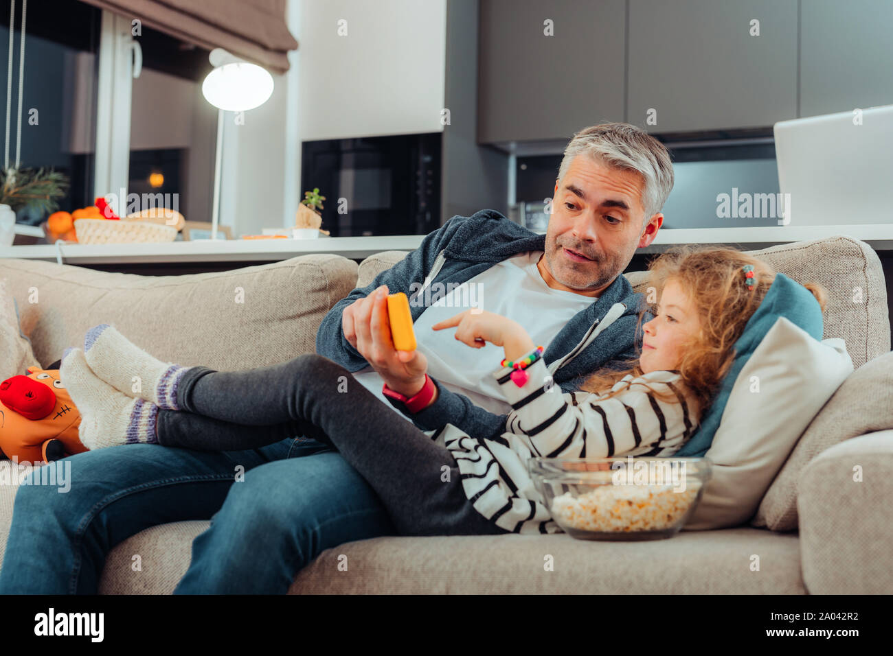 Look Here Pleased Kid Lying On Sofa While Having Lazy Day At Home