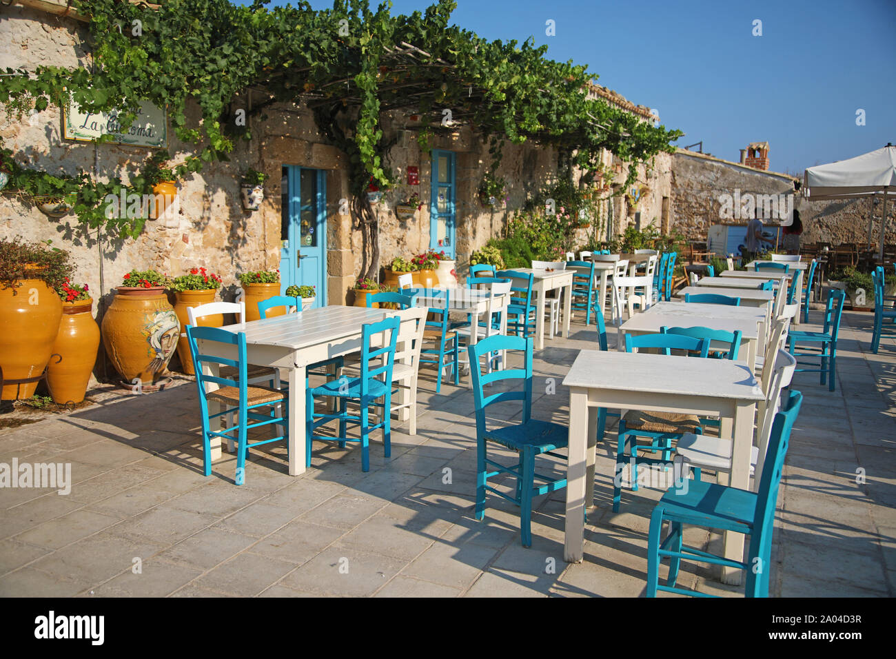 Outdoor tables of restaurant in Marzamemi, Sicily Stock Photo
