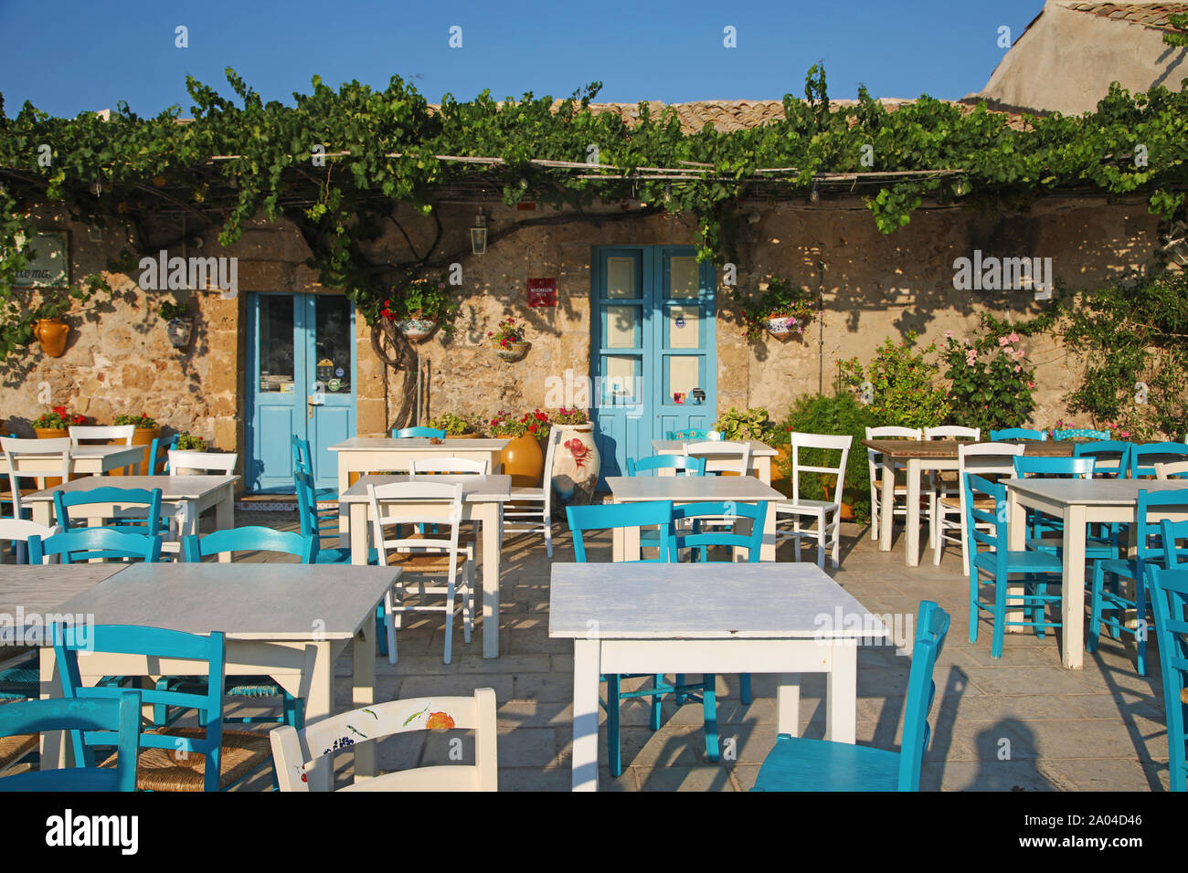 Outdoor tables of restaurant in Marzamemi, village of Sicily Stock Photo