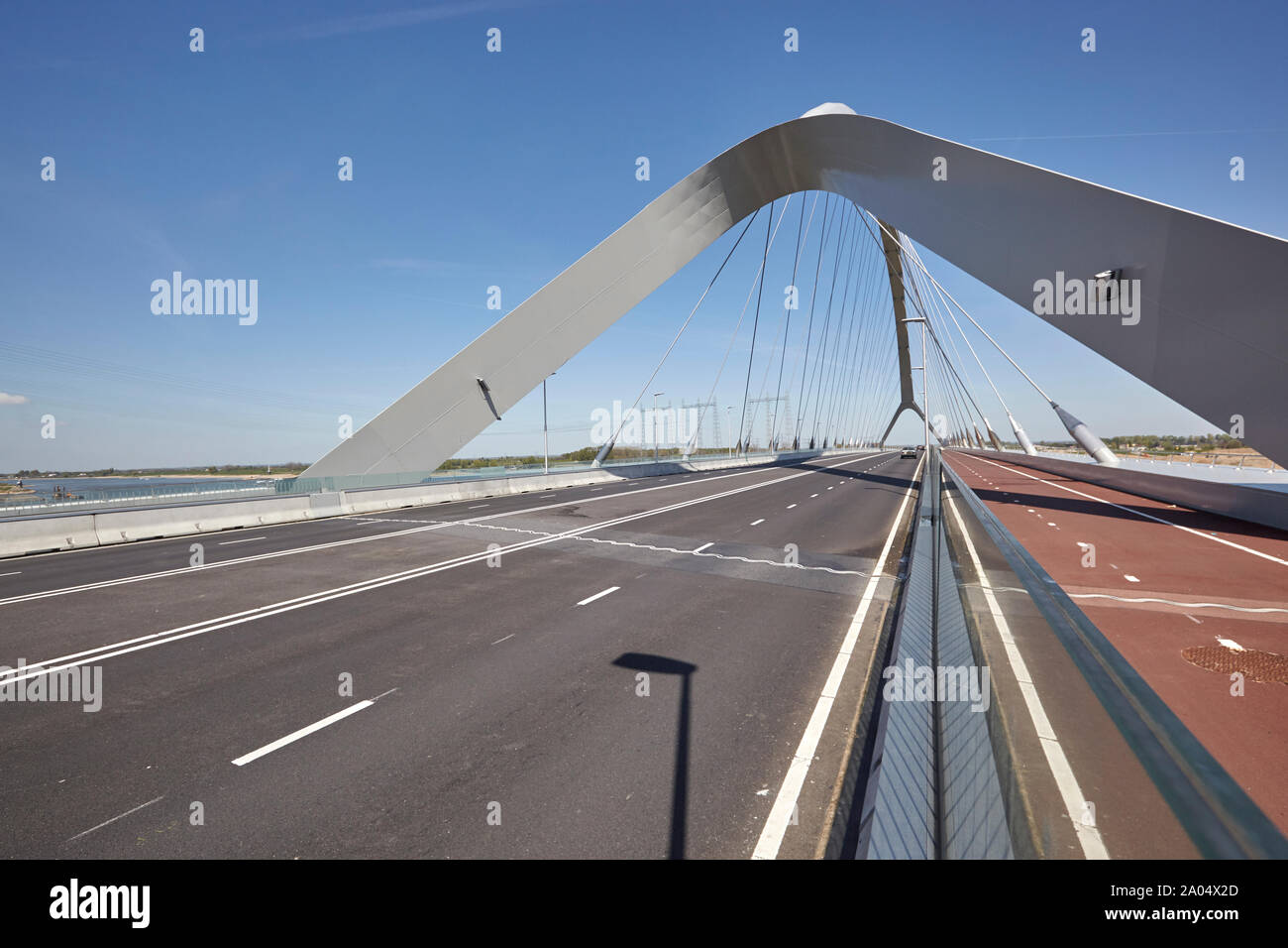 Bridge deck and asymmetrical bowstring span of the Oversteek bridge which spans the river Waal at Nijmegen, Netherlands Stock Photo
